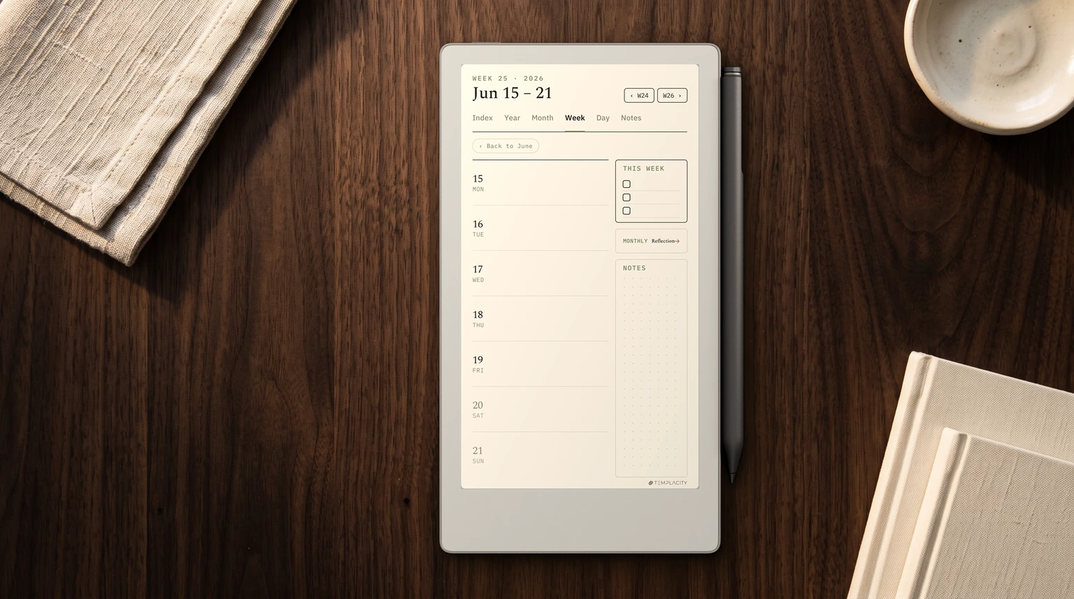 A reMarkable Paper Pro Move on a walnut desk, its tall 9:16 portrait screen showing a weekly planner page