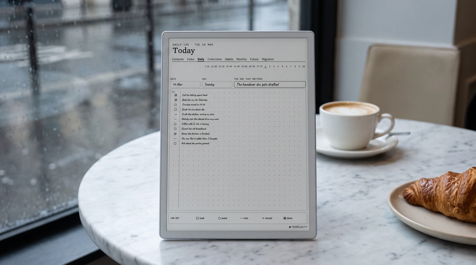 The Logbook System daily log on an e-ink tablet on a marble cafe table